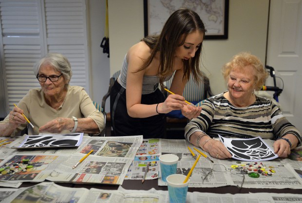 Izzy Sehon, center helping Josephine Lancaster left and Natalie Pukszta