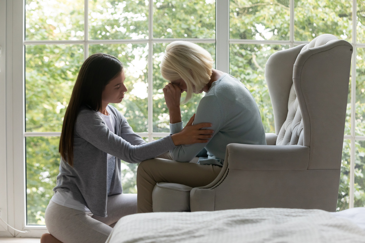 Nurse giving support to senior woman