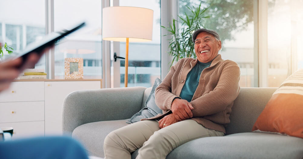 A person sitting on a couch laughing