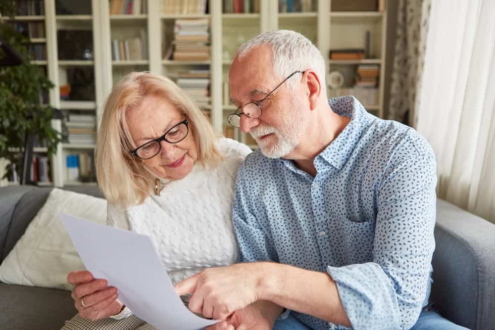 An elderly couple reviewing paper work