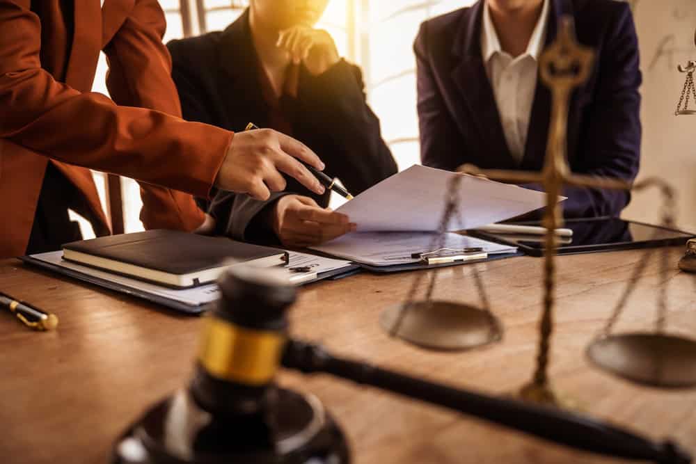Lawyers reviewing paper work.