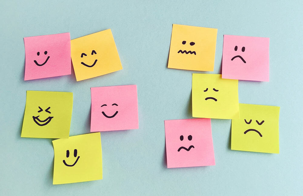 Sticky notes with different faces drawn on them to show emotions