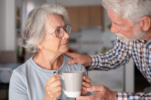 A man helping a woman with a drink