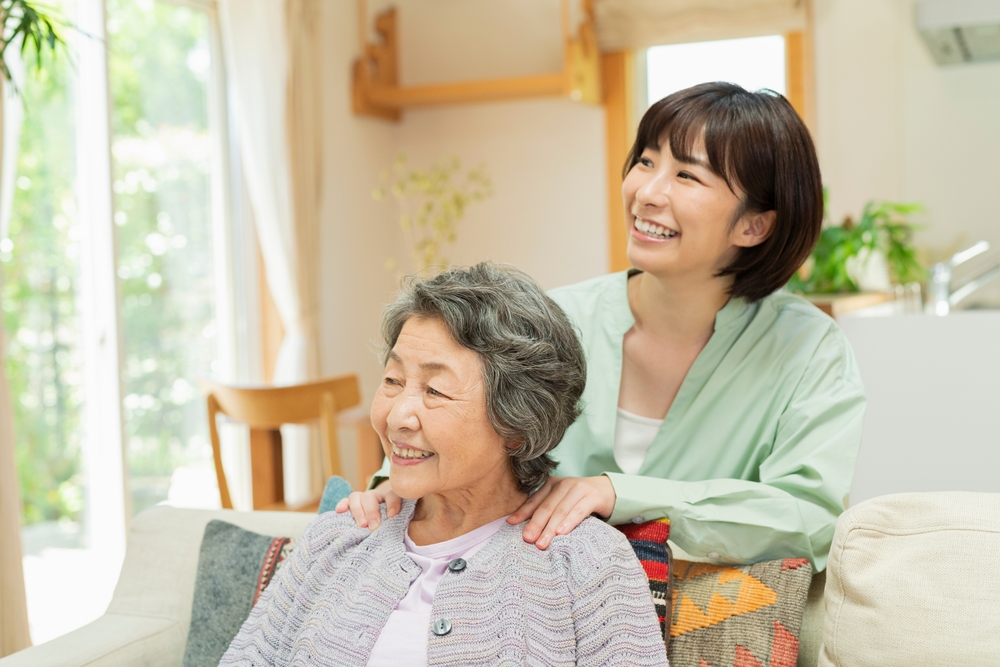 A mother and daughter smiling and interacting in their living room