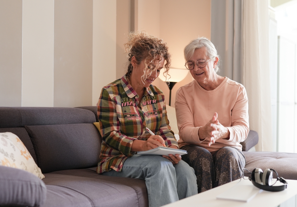 A person taking notes for an older resident