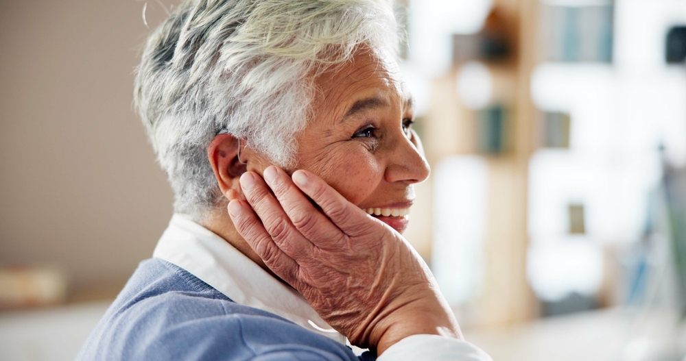 A woman shown wearing a hearing aid