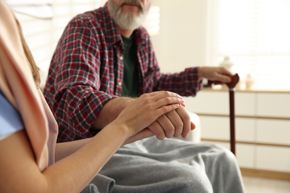 A person lending a helping hand to an older resident